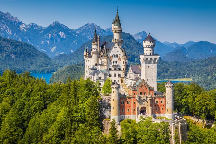 a castle with Neuschwanstein Castle in the background